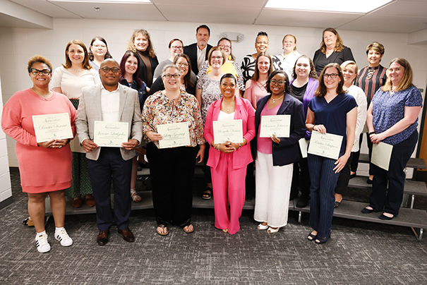 Volunteers stand with awards for serving the district